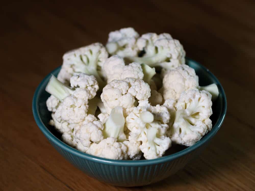 Cauliflower florets in a blue bowl