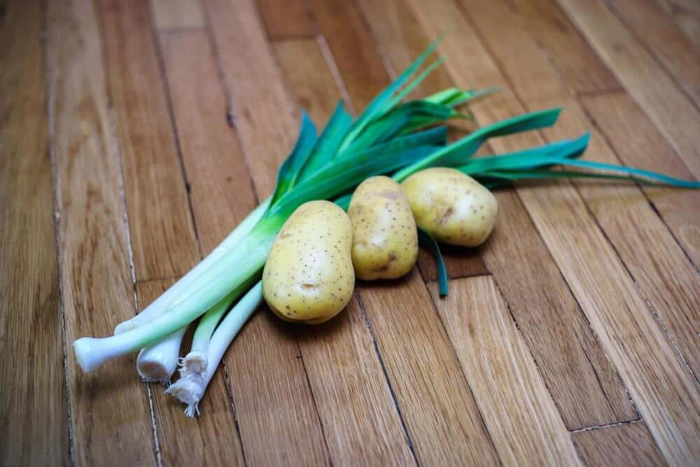 Leeks and potatoes on a table