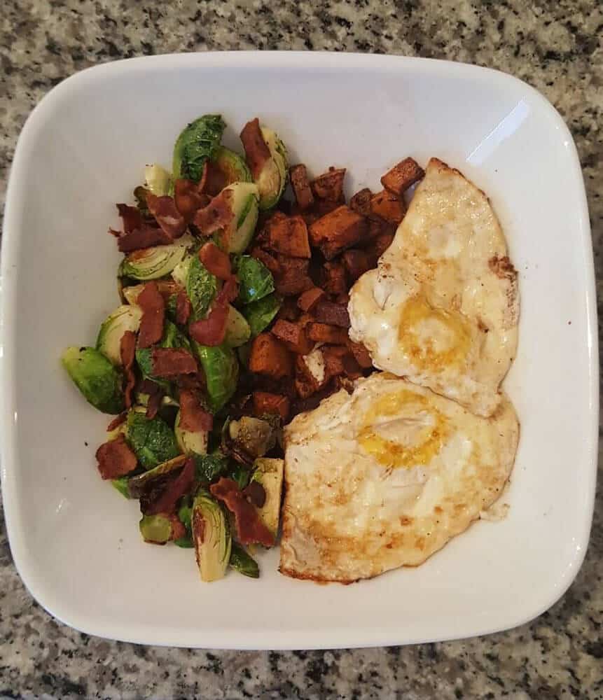 Sweet potato brussels sprouts and eggs on a plate