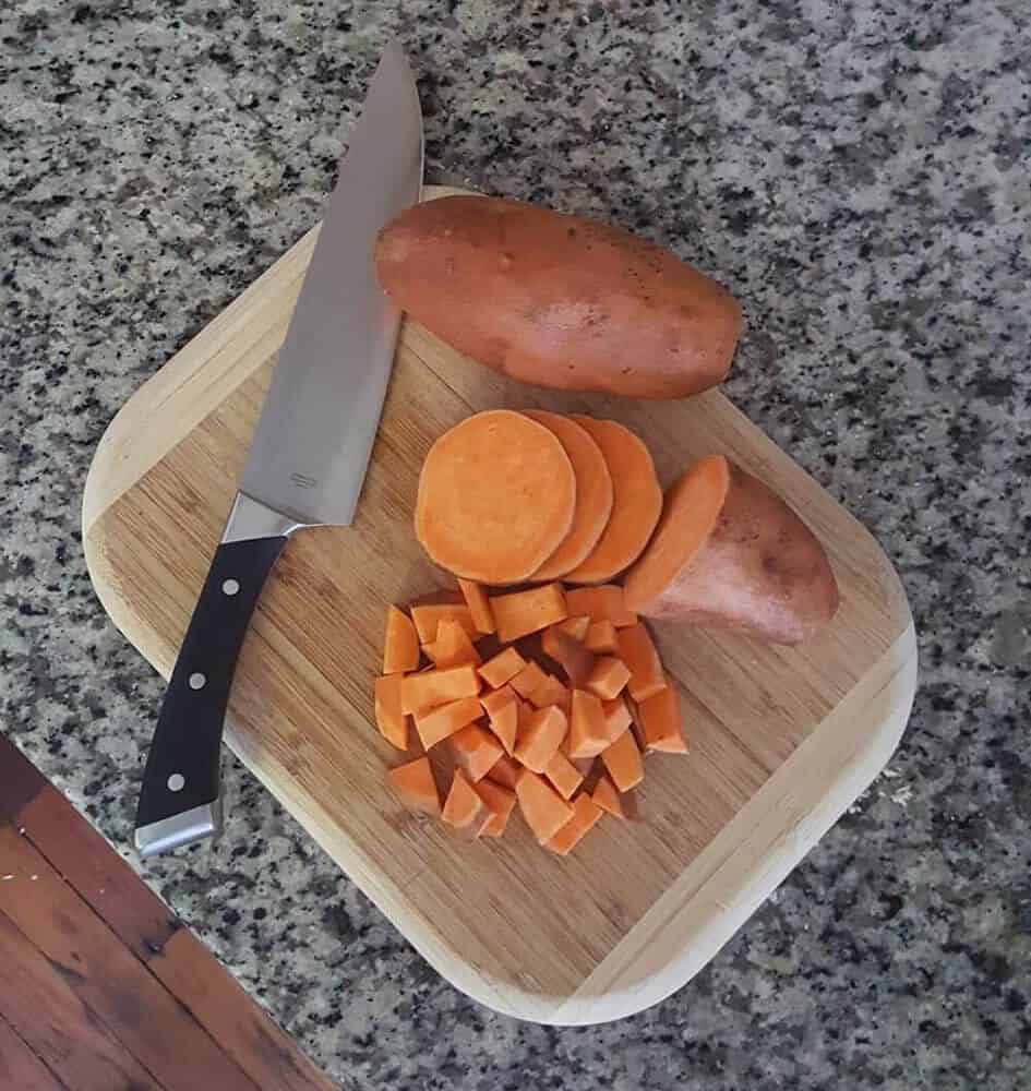 Sweet potato on wooden chopping board