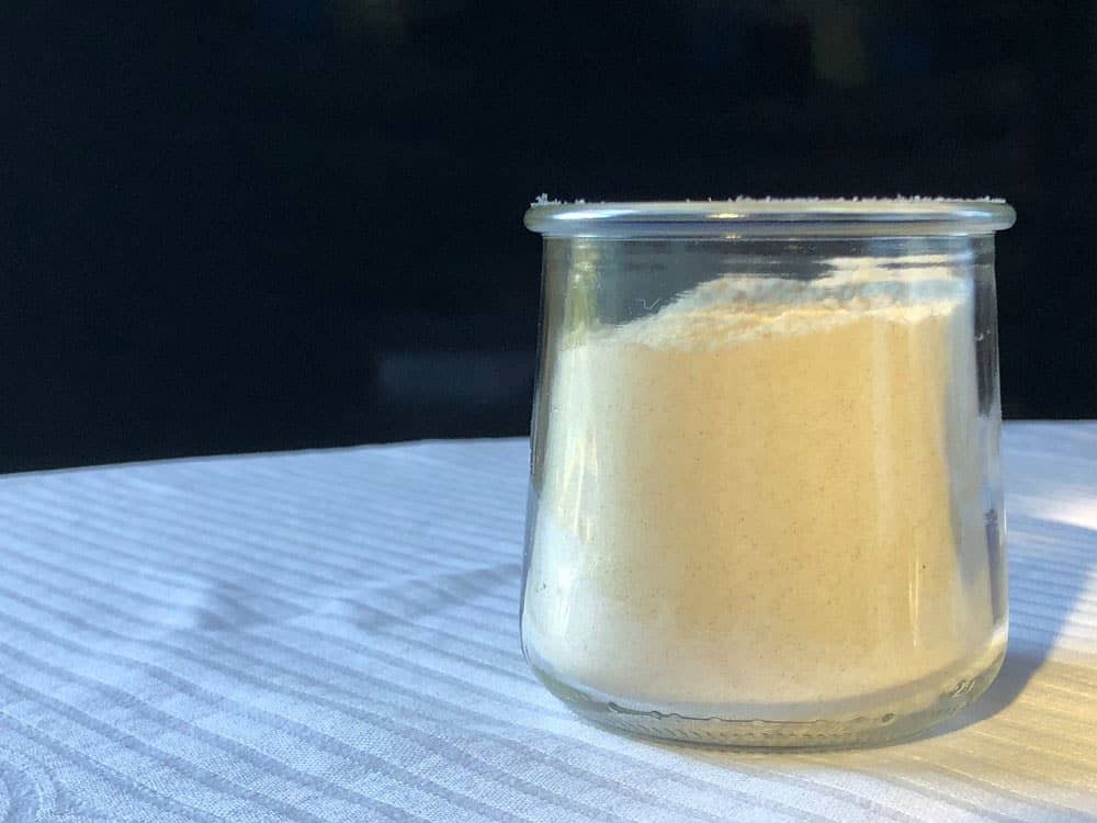 Measuring flour in a yogurt pot