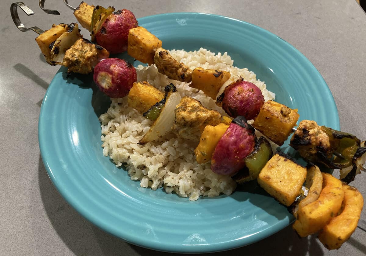 Kebabs on rice and a blue plate