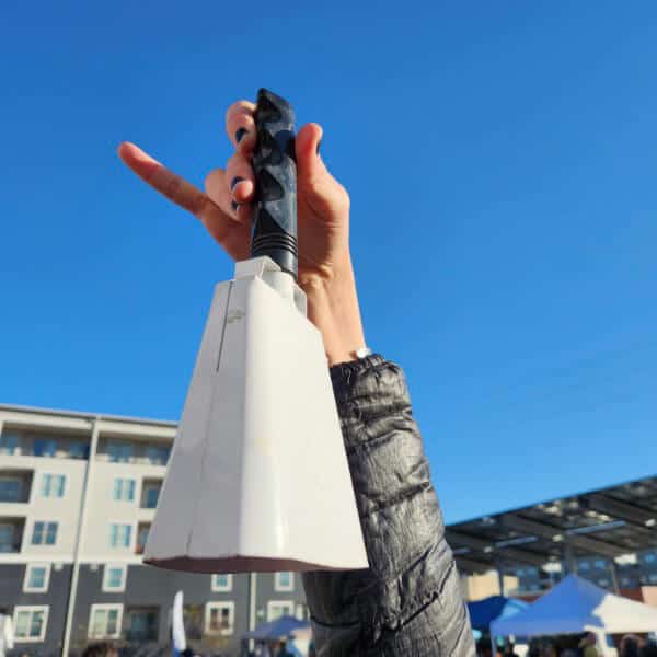 person holding the market opening bell